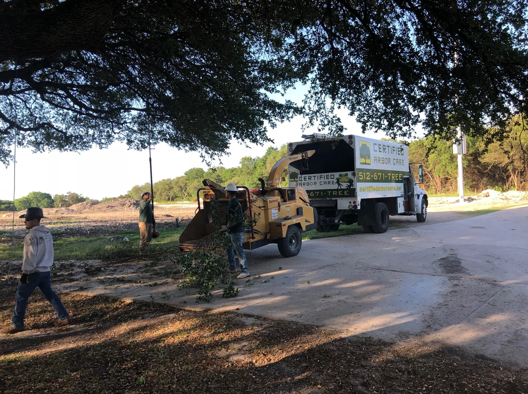 Certified Arbor Care crew and chipper on a commercial property
